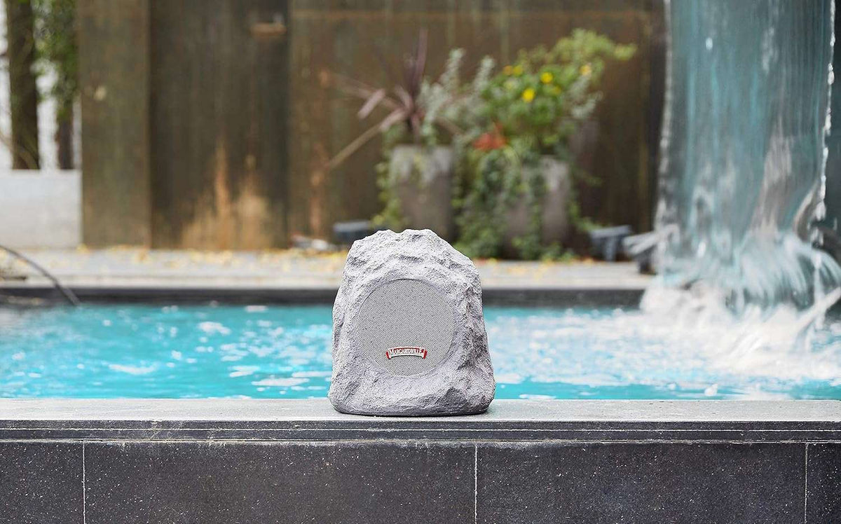 Outdoor Rock Bluetooth speaker in granite grey with textured stone-like design, compact and waterproof for outdoor use.