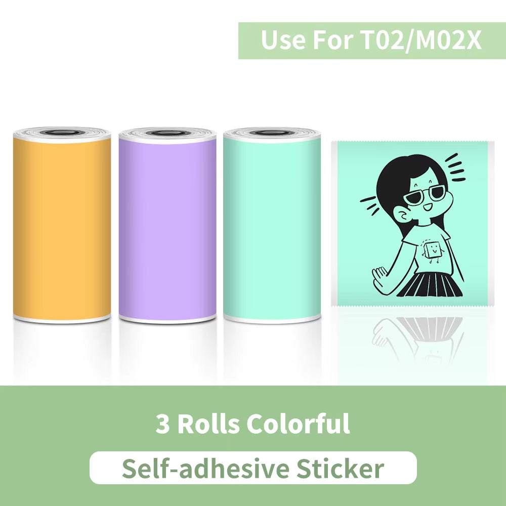 Self-adhesive sticker rolls in orange, purple, and mint green thermal paper designed for Portable Printer with printed cartoon on mint green roll.