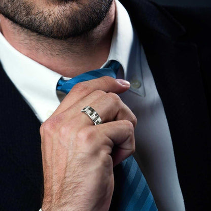 Smart Ring Health Tracker in silver metal worn on a man's finger, featuring a sleek design with rectangular patterns on its surface