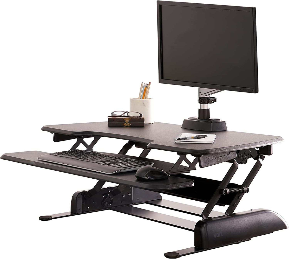 Two-Tier Standing Desk converter in black with adjustable height, dual-handle lift, and separate keyboard tray for ergonomic workspace.