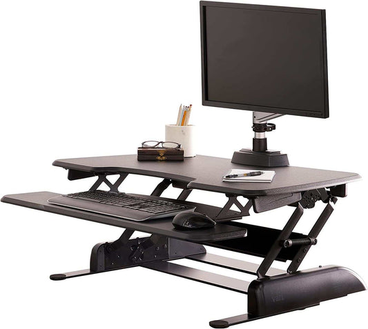 Two-Tier Standing Desk converter in black with adjustable height, dual-handle lift, and separate keyboard tray for ergonomic workspace.
