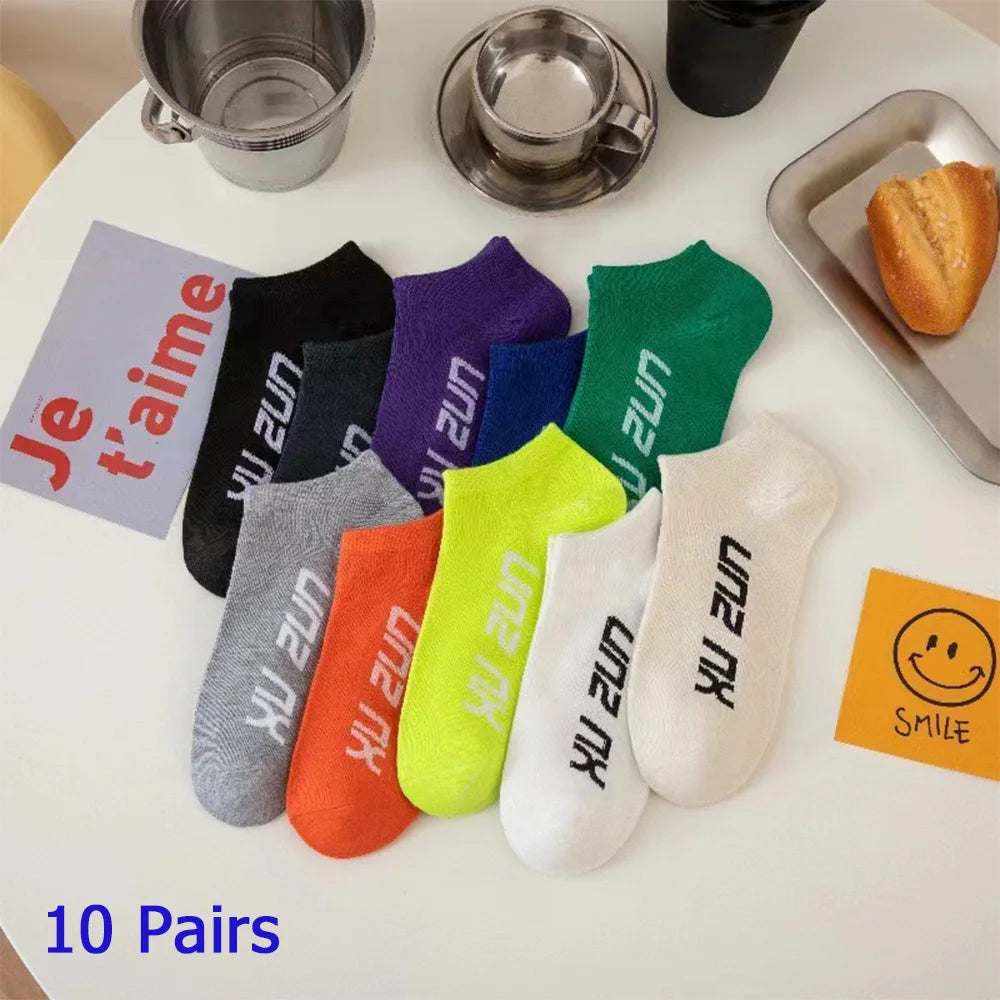 Women/Men Boat Socks in assorted colors including black, gray, orange, white, green, blue, and purple with white printed text on ankle area