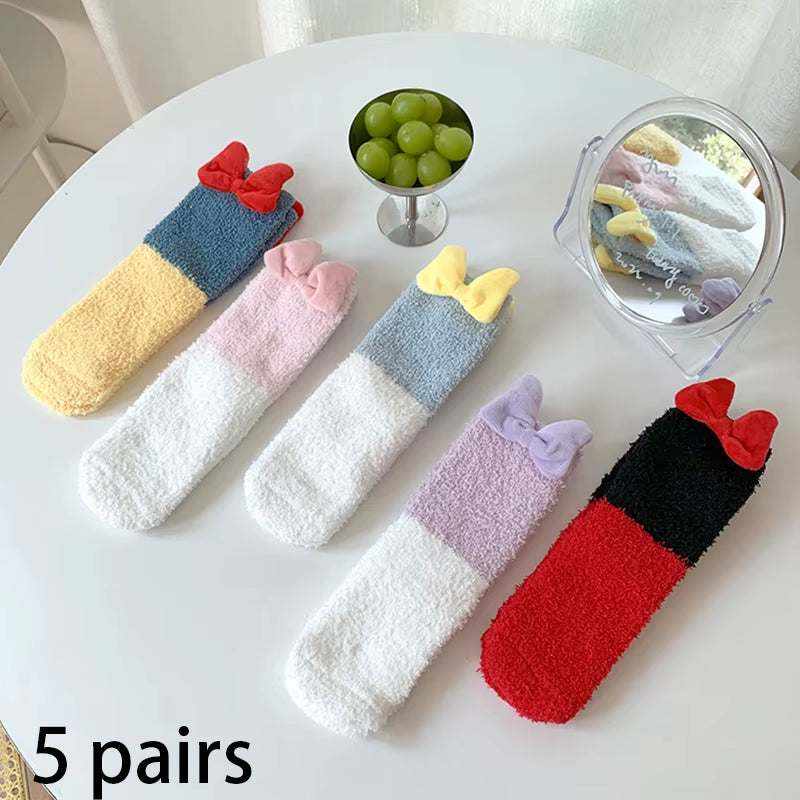 Five pairs of colorful fuzzy socks with bows in red, pink, yellow, purple, and black with red, designed as Women/Men Boat Socks for comfort and style