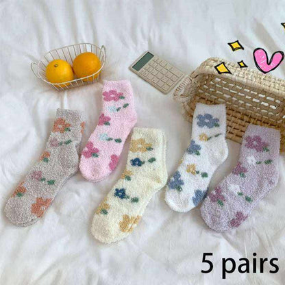 Five pairs of Women/Men Boat Socks in pastel colors with fluffy texture and floral patterns laid out on a white surface